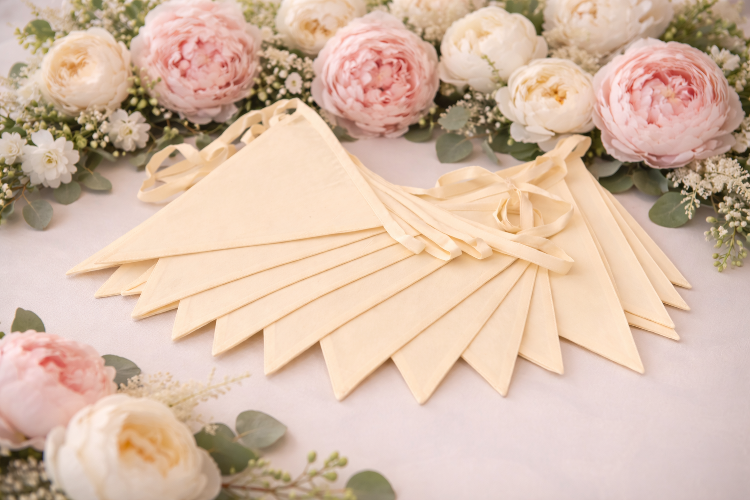 Decorative flags on a table with flowers in the background