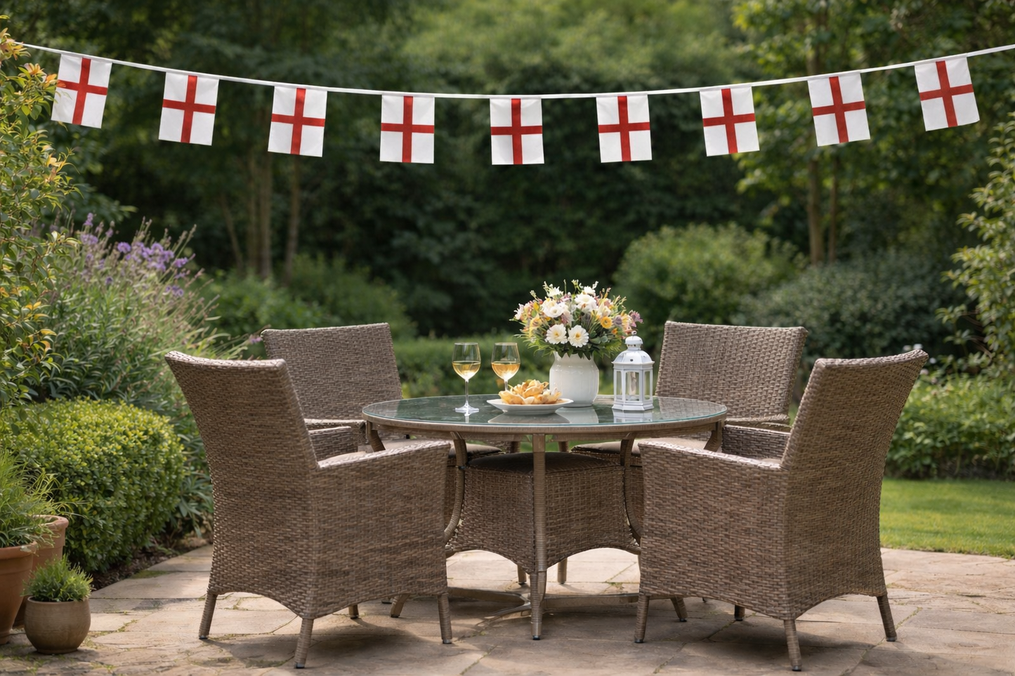 Outdoor patio set with table and chairs under a string of English flag bunting.