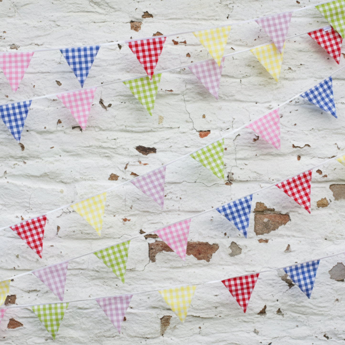 Colourful checkered triangle flags on a wooden background