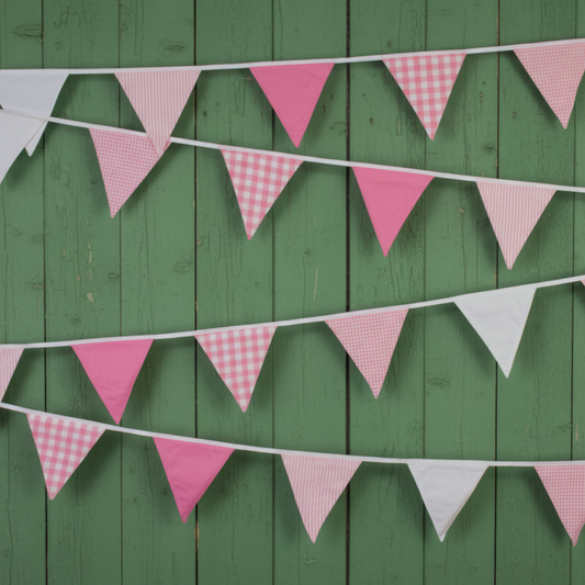 Pink and white checkered bunting flags on a green wooden background