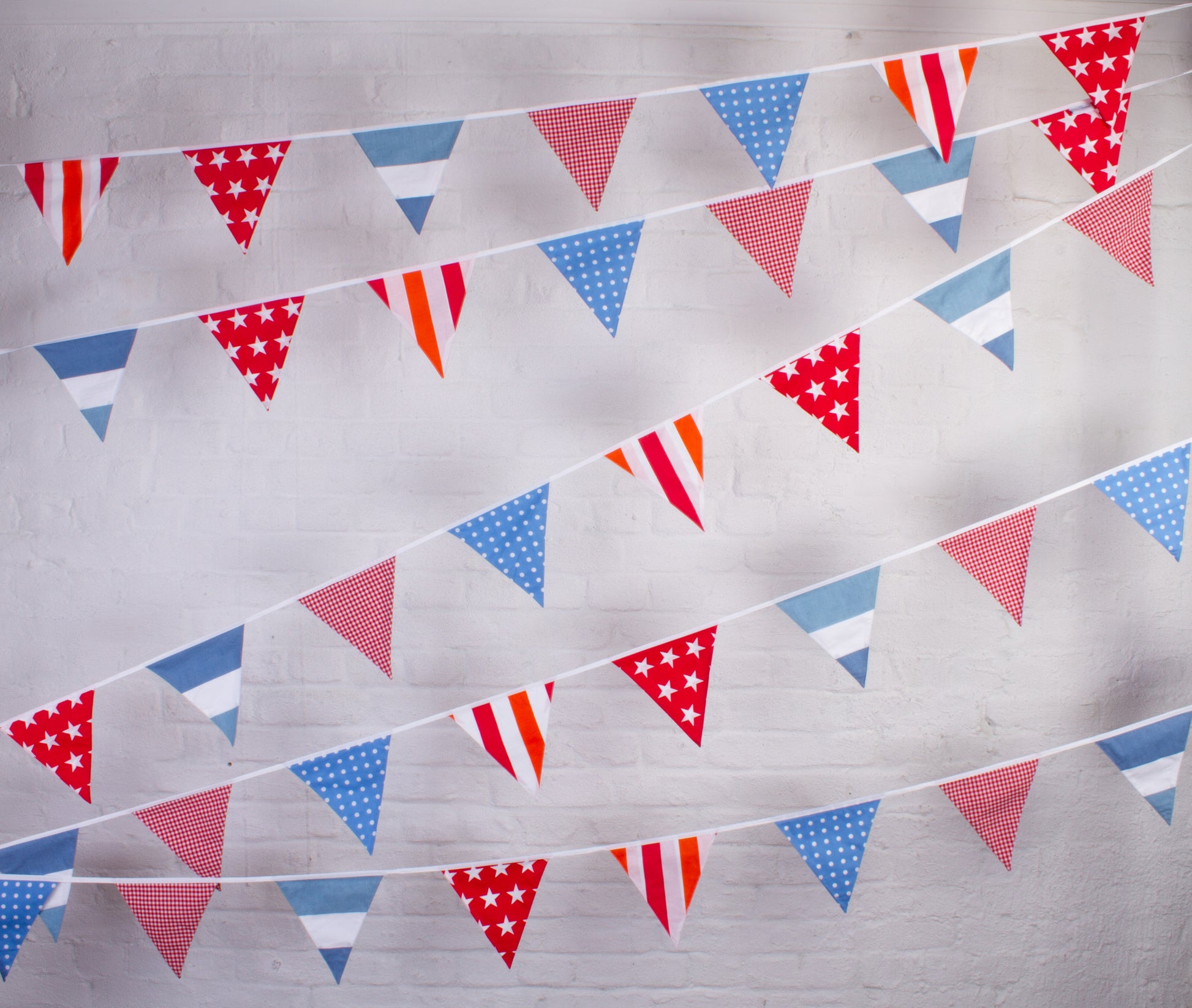 String of red, white, and blue triangular flags on a bunting