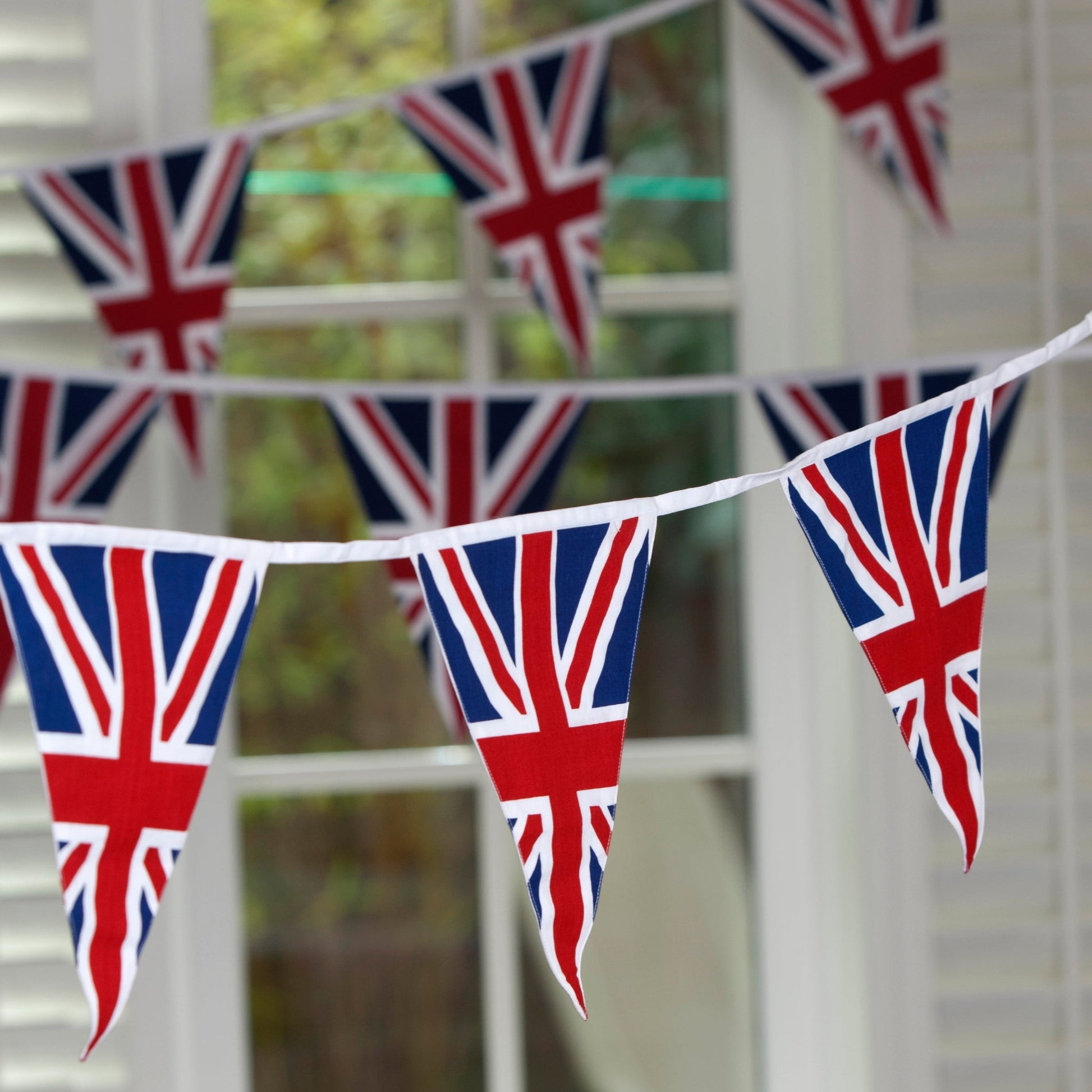 Union Jack flag bunting hanging in front of a window